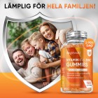 Bilden visar en glad familj i bakgrunden och en burk av C-Vitamin Gummies för att visa att den går att ge för hela familjen